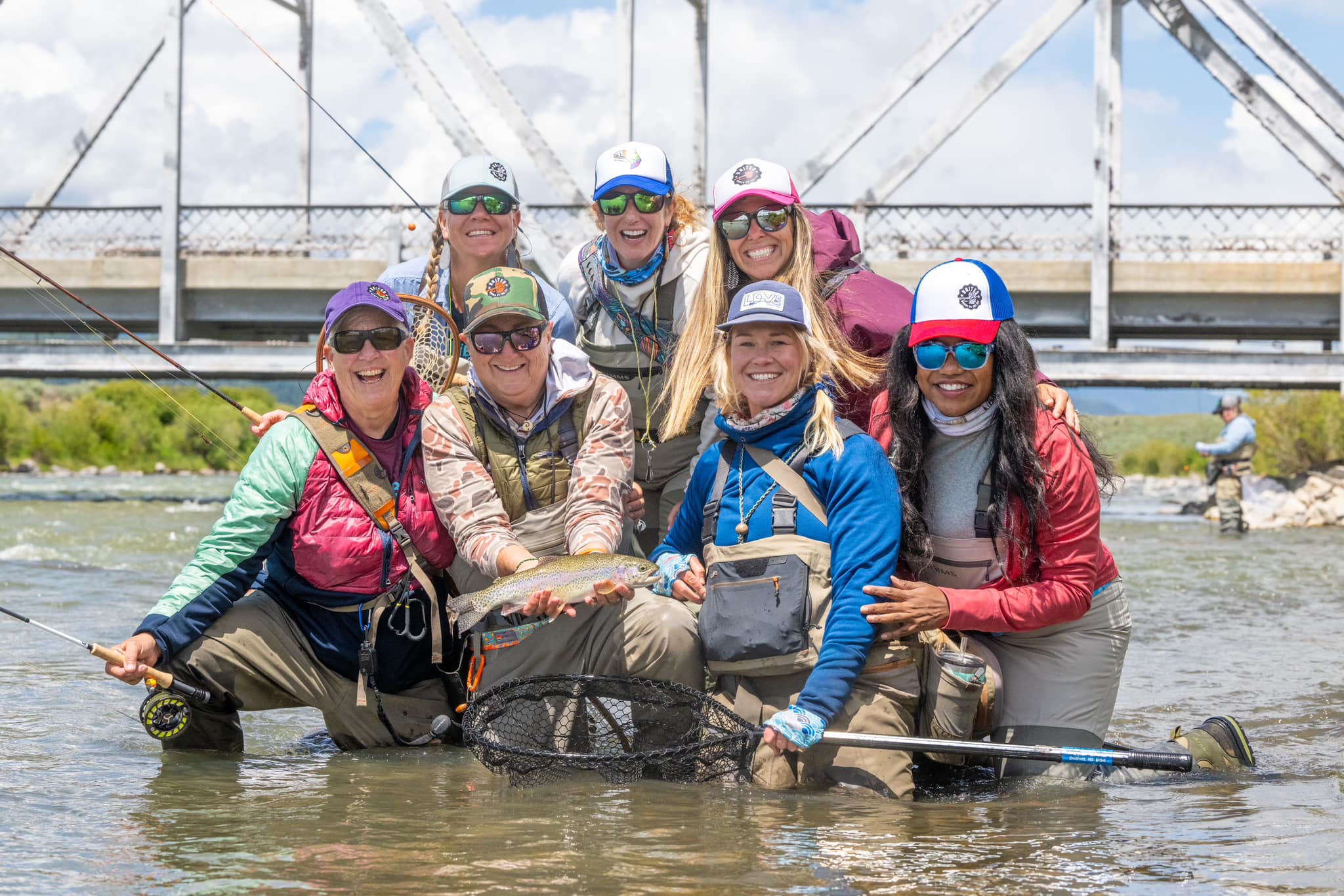 Group photo of women fly fishing with fish in Montana.